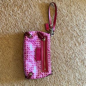 Magenta and brown Coach wristlet bag
